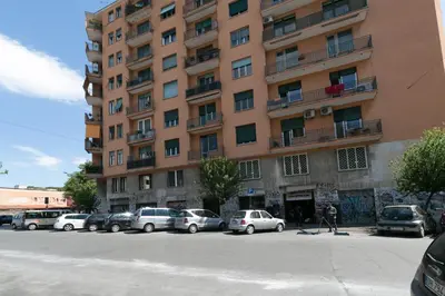 a tall building with cars parked in front of it at Domus Klimt in Rome
