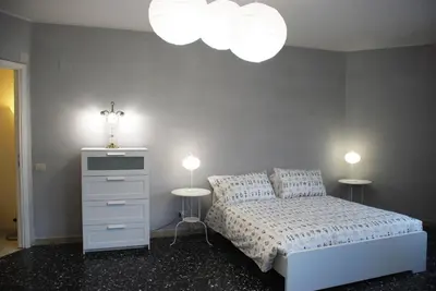 a bedroom with a bed with two lamps and a dresser at Domus Klimt in Rome