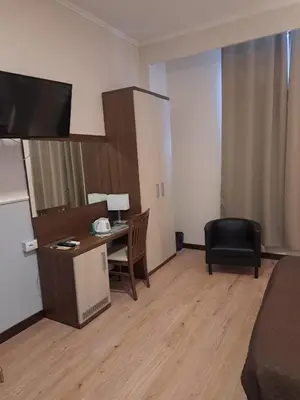 a living room with a desk and a chair at Hotel Leone in Rome