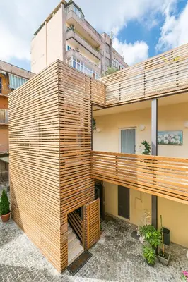 a building with wooden panels on the side of it at Aeterno Eco Guest House in Rome