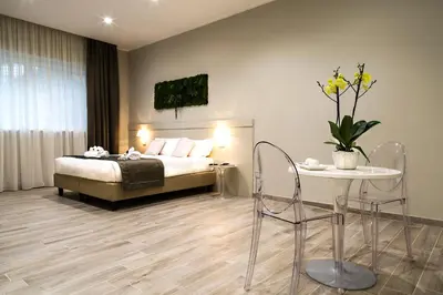 a bedroom with a bed and a table and chairs at Aeterno Eco Guest House in Rome
