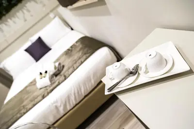 a hotel room with a bed and a table with towels at Aeterno Eco Guest House in Rome