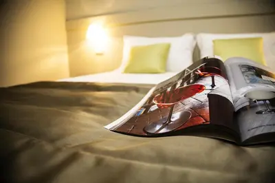 a book sitting on top of a bed at Aeterno Eco Guest House in Rome
