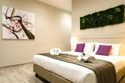 a bedroom with a bed with two stuffed animals on it at Aeterno Eco Guest House in Rome