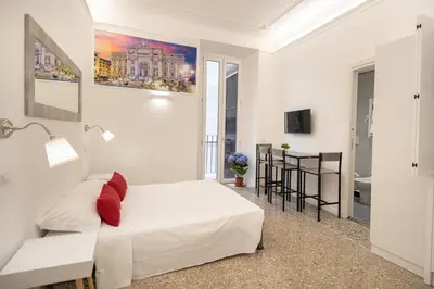 a white bedroom with a bed and a table at Your Vatican Suite in Rome