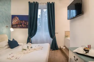 a room with a bed and a window with curtains at Your Vatican Suite in Rome
