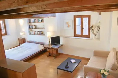 a bedroom with a bed and a desk with a computer at Casa Paradiso in Rome