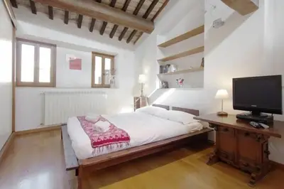 a bedroom with a bed and a tv on a desk at Casa Paradiso in Rome
