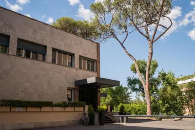 a building with a tree in front of it at Hotel Villa Maria Regina in Rome