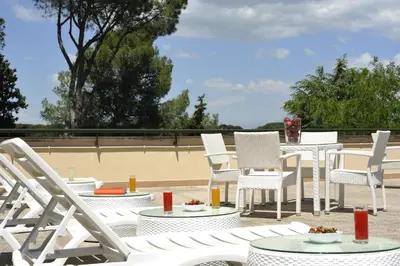 a group of chairs and tables on a patio at Hotel Villa Maria Regina in Rome
