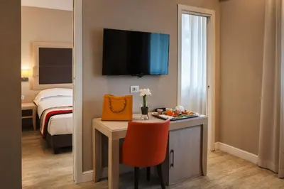 a room with a desk and a room with a bed at Hotel Villa Maria Regina in Rome