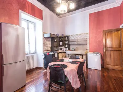 a kitchen with a table and a refrigerator at Apartment Spanish Steps by Interhome in Rome