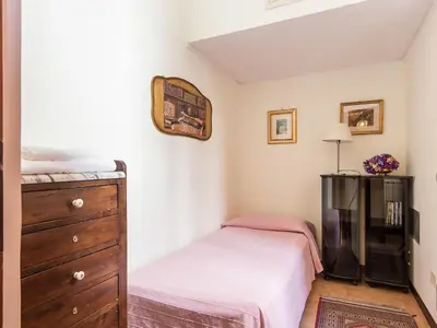 a bedroom with two twin beds and a dresser at Apartment Spanish Steps by Interhome in Rome