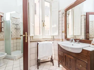a bathroom with a sink and a toilet and a tub at Apartment Spanish Steps by Interhome in Rome