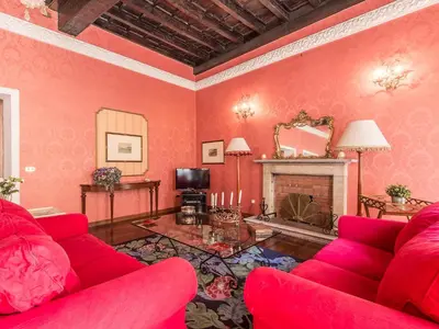 a living room with red furniture and a fireplace at Apartment Spanish Steps by Interhome in Rome
