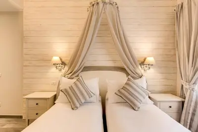 two beds in a bedroom with two curtains at Casa Mia Vaticano Guest House in Rome
