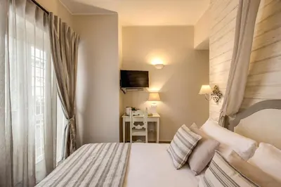 a hotel room with a bed and a television at Casa Tua Vaticano Guest House in Rome