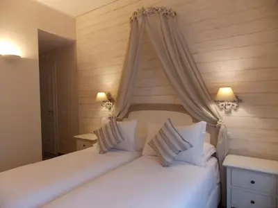 a bedroom with two white beds with a canopy at Casa Tua Vaticano Guest House in Rome