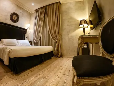 a hotel room with a bed and a chair at MDM Guesthouse in Rome