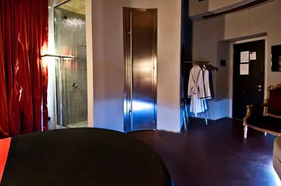 a room with a table and a closet with a glass door at MDM Guesthouse in Rome