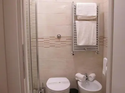 a small bathroom with a toilet and a sink at Trevi Elegance Suite in Rome