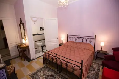 a bedroom with a bed with a red bedspread at Giubiliana in Rome
