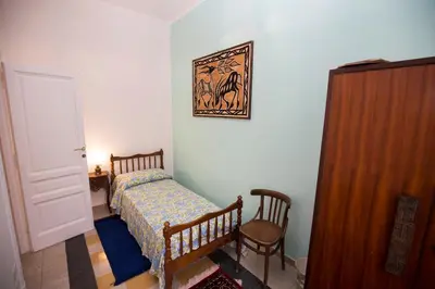 a bedroom with a bed and a picture on the wall at Giubiliana in Rome