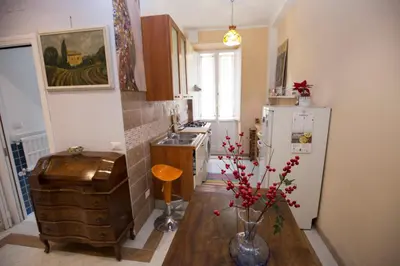 a kitchen with a table and a refrigerator at Giubiliana in Rome