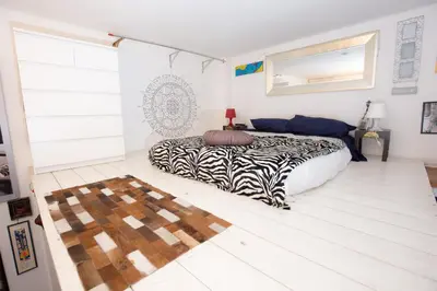 a bedroom with a zebra print bed in a room at Sweet Dream Penthouse in Rome