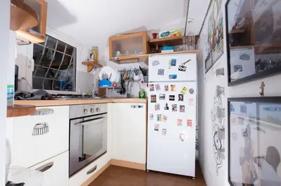 a kitchen with two white refrigerators with magnets on them at Sweet Dream Penthouse in Rome