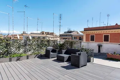a patio with two chairs and a fence at Sweet Dream Penthouse in Rome
