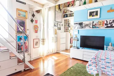 a room with a staircase and a tv in it at Sweet Dream Penthouse in Rome