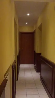 a hallway with a brown door and a tile floor at 3 Lati di Pitagora B&B in Rome
