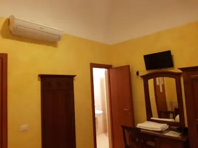 a bathroom with a mirror and a air conditioner on the wall at 3 Lati di Pitagora B&B in Rome