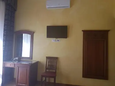 a room with a desk and a television on the wall at 3 Lati di Pitagora B&B in Rome