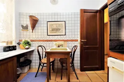 a kitchen with a table and chairs in a kitchen at Bellezza Al Colosseo - B&B & Apts in Rome