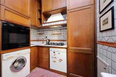 a small kitchen with a washing machine and a washer at Bellezza Al Colosseo - B&B & Apts in Rome
