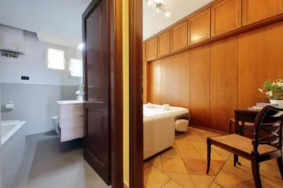 a room with a bed and a table and a chair at Bellezza Al Colosseo - B&B & Apts in Rome