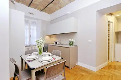 a kitchen and dining room with a table and chairs at Bellezza Al Colosseo - B&B & Apts in Rome