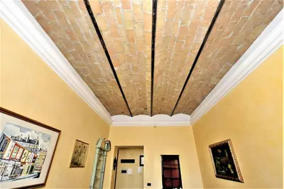 a room with a ceiling with a brick at Bellezza Al Colosseo - B&B & Apts in Rome