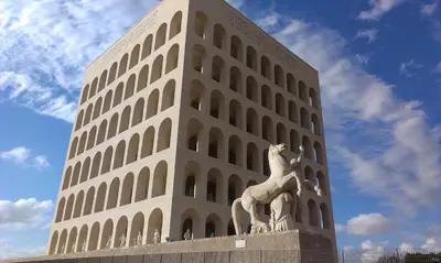a tall building with a statue in front of it at Tintoretto Inn B&B in Rome