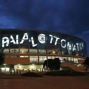 a large building with a sign on it at night at Tintoretto Inn B&B in Rome