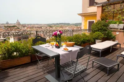 a table and chairs on a balcony with a view at Hotel Scalinata Di Spagna in Rome