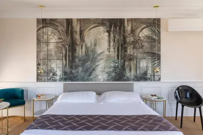 a bedroom with a bed and a painting on the wall at Hotel Scalinata Di Spagna in Rome