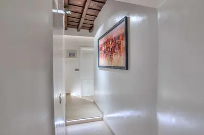 a hallway with a painting hanging on a wall at Spagna Luxury'n Trevi in Rome