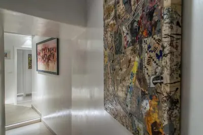 a large painting on a wall in a hallway at Spagna Luxury'n Trevi in Rome