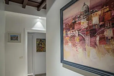 a large painting hanging on a wall in a room at Spagna Luxury'n Trevi in Rome