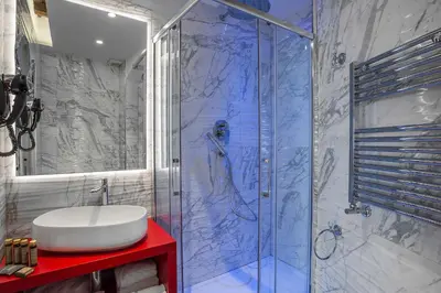 a bathroom with a sink and a glass shower at Spagna Luxury'n Trevi in Rome