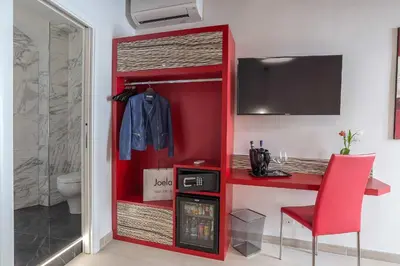 a red closet with a red desk and a red chair at Spagna Luxury'n Trevi in Rome