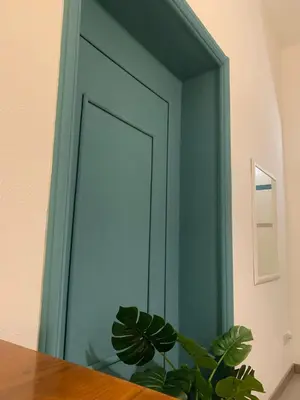 a green door with a plant in front of it at Mc - Piazza Mancini in Rome
